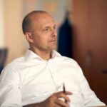 Professional portrait of a thoughtful businessman in an office setting in Bratislava, Slovakia.